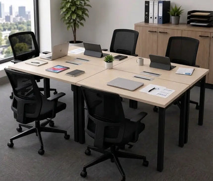 A modern workstation office table setup with a light wood grain rectangular desk.